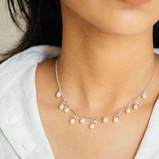 Arlette Charms freshwater pearl and 92.5 sterling silver necklace set worn by model with delicate pearl drop charms