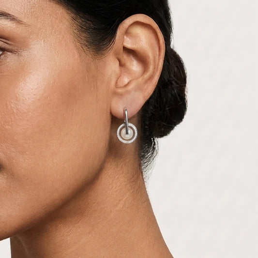 A Model Showcasing Pearl Stud Earrings In A Sophisticated Silver Pearl Jewellery Set Circular Style.