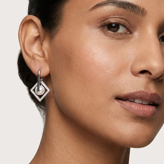 A Model Wearing Elegant Pearl Earrings Hanging In A Contemporary Silver Pearl Jewellery Set Style.