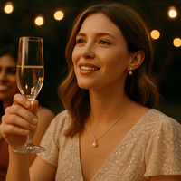 Woman wearing elegant pearl earrings and necklace at a celebration
