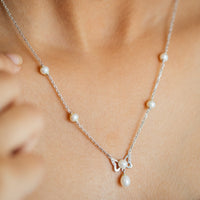 Women Wearing Silver Pearl Earrings