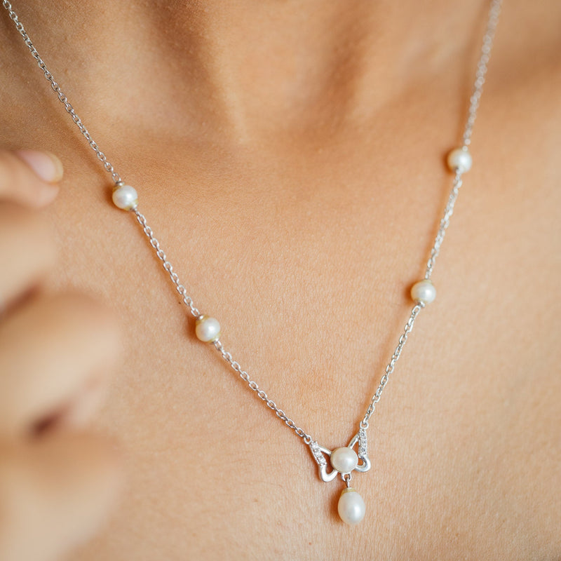 Women Wearing Silver Pearl Earrings