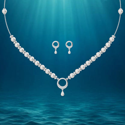 Artistic rendering of a silver halo jewelry set floating in a deep blue underwater scene with shimmering light