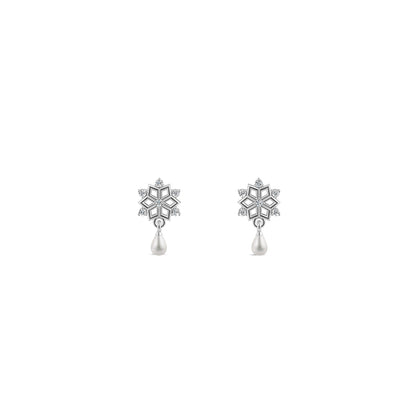 Silver snowflake jewelry set glowing against a dark blue underwater background with sunbeams