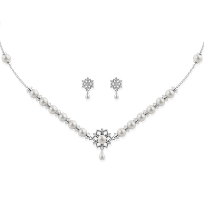 Ornate silver snowflake pendant necklace with matching floral-inspired stud earrings on a white background