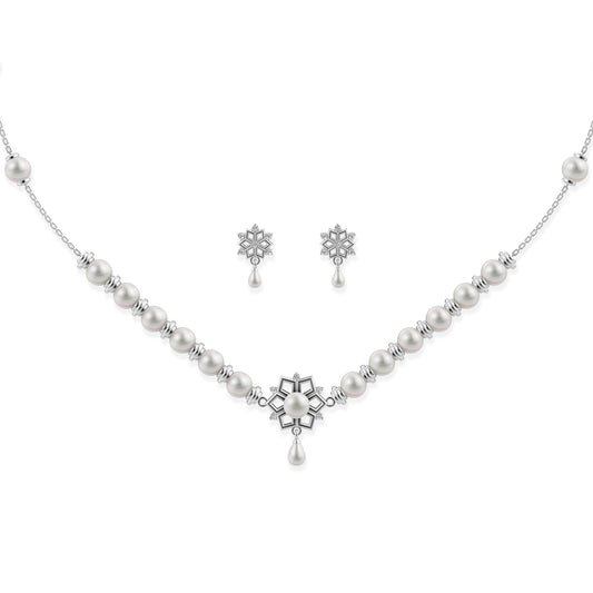 Ornate silver snowflake pendant necklace with matching floral-inspired stud earrings on a white background