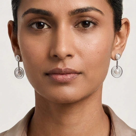A Model Wearing Pearl Earrings Hanging In A Sophisticated Silver Pearl Jewellery Set Style For Formal Occasions.