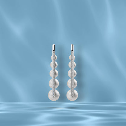 High-Quality Freshwater Pearl Earrings Displayed Against A Blue Silk Backdrop Highlighting Original Pearl Earrings.