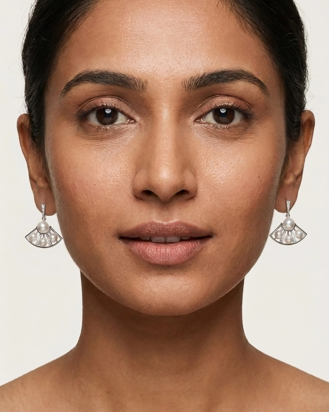 A Model wearing White Pearl Earrings Hanging in a stylish Silver Pearl Jewellery Design perfect for a Pearl Jewellery Set.