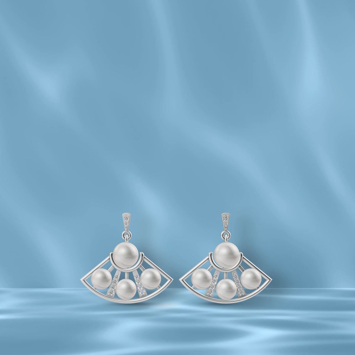 Beautifully crafted Freshwater Pearl Earrings in silver showcasing Original Pearl Earrings on a blue silk background.