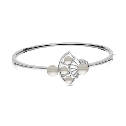 Side angle view of a thin silver kada featuring a central pearl-embellished fan centerpiece.
