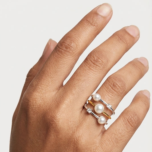 A Model Wearing A Modern Pearl Ring For Women Showcasing A Stylish Silver Pearl Ring Stacked Effect On The Finger.