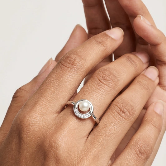 Silver Pearl Moon Ring with Diamond Detailing worn on a Person's Hand.