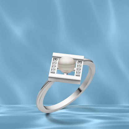 Silver Pearl Square Ring with Diamond Detailing displayed against a Wavy Light Blue Silk Background
