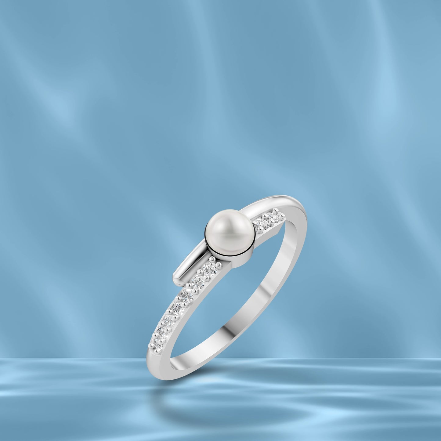 High-Quality White Pearl Silver Ring Displayed On A Blue Silk Background Highlighting Modern Pearl Ring Designs For Ladies.