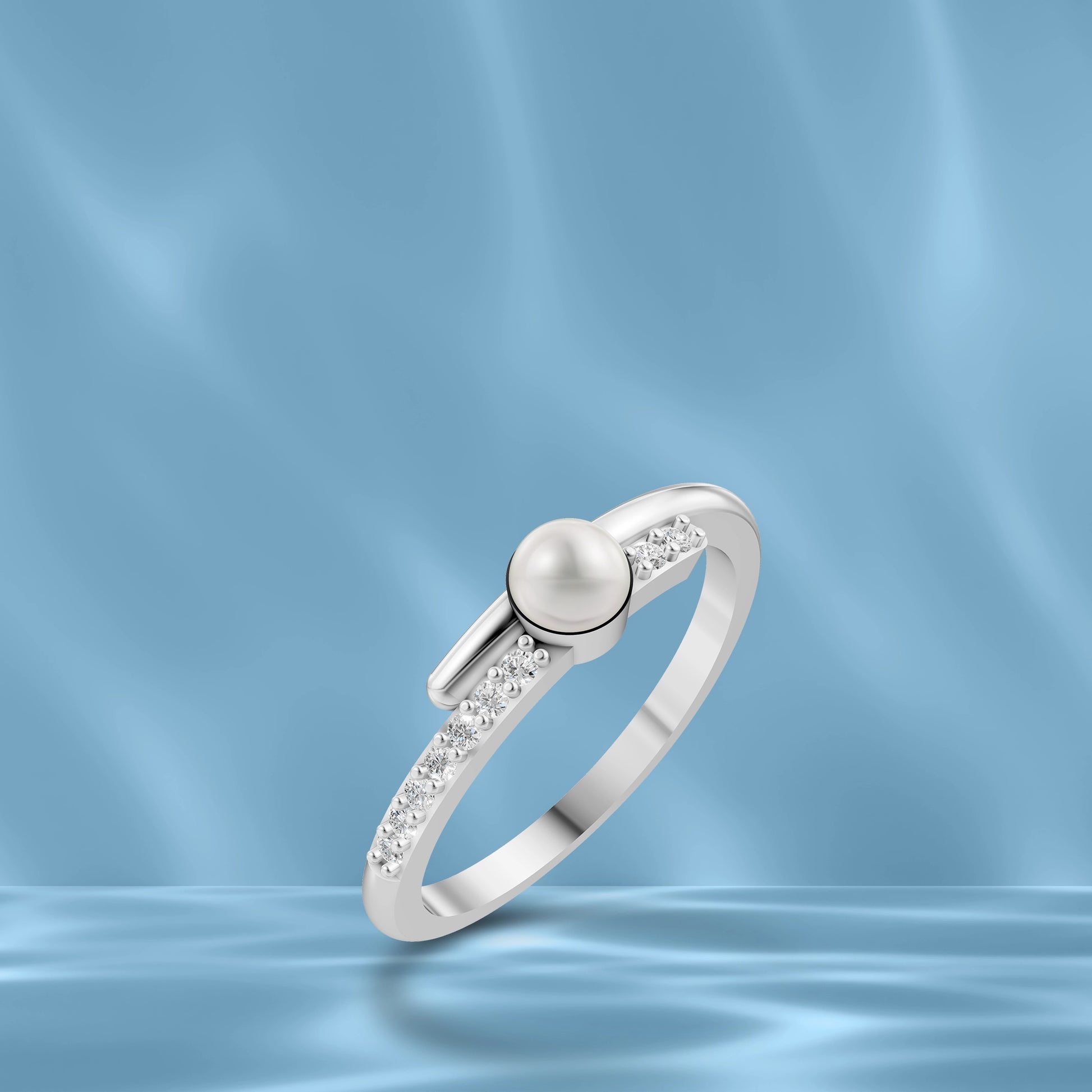 High-Quality White Pearl Silver Ring Displayed On A Blue Silk Background Highlighting Modern Pearl Ring Designs For Ladies.