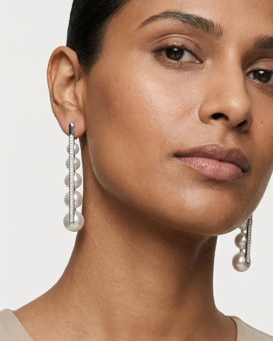 A Model Wearing Pearl Earrings Hanging In A Modern Silver Pearl Jewellery Drop Style For An Elegant Look.